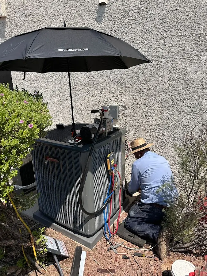 HVAC technician performing outdoor AC maintenance in East Rutherford